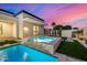 Beautiful pool and spa in backyard featuring turf, stacked stone and modern design at 8549 E Indianola Ave, Scottsdale, AZ 85251