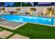 Backyard swimming pool with water features, turf and desert landscaping at 8549 E Indianola Ave, Scottsdale, AZ 85251