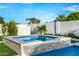 This spa is accented by the beautiful pool, landscaping, and stone accents in this backyard escape at 8549 E Indianola Ave, Scottsdale, AZ 85251
