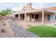 Large backyard features a covered patio and rock garden offering a tranquil retreat at 8635 W Country Gables Dr, Peoria, AZ 85381