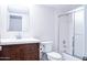 Well-lit bathroom features a modern vanity, mirror, toilet, and shower with glass doors at 8635 W Country Gables Dr, Peoria, AZ 85381