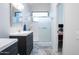 Bright bathroom featuring dual vanities, a shower with glass door, and modern fixtures at 8635 W Country Gables Dr, Peoria, AZ 85381