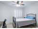 Bright bedroom featuring shuttered windows, a ceiling fan, and neutral colors at 8635 W Country Gables Dr, Peoria, AZ 85381