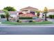 Community entrance with stone monument, mature landscaping, and well-maintained street at 8635 W Country Gables Dr, Peoria, AZ 85381
