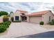Charming home featuring a red tile roof, neutral stucco exterior, and well-manicured landscaping at 8635 W Country Gables Dr, Peoria, AZ 85381