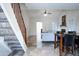 Bright living area featuring an adjacent dining room with lots of natural light and staircase at 8635 W Country Gables Dr, Peoria, AZ 85381