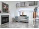 Open-concept living room with fireplace, modern flooring, and staircase to the upper level at 8635 W Country Gables Dr, Peoria, AZ 85381