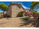 Expansive backyard featuring a covered patio, artificial turf, and desert landscaping at 9343 W Quail Ave, Peoria, AZ 85382