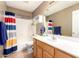 Cozy bathroom featuring a single sink vanity and a shower with a colorful striped curtain at 9343 W Quail Ave, Peoria, AZ 85382