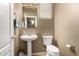 Powder bathroom featuring a pedestal sink, a mirror and a toilet at 9343 W Quail Ave, Peoria, AZ 85382