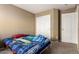 This bedroom features neutral walls, carpet flooring, and a closet with mirrored doors at 9343 W Quail Ave, Peoria, AZ 85382