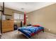 This bedroom features neutral walls, carpet flooring, and a window bringing in plenty of natural light at 9343 W Quail Ave, Peoria, AZ 85382