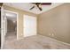 This bedroom features neutral walls, carpet flooring, and a closet with mirrored doors at 9343 W Quail Ave, Peoria, AZ 85382