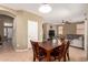 Cozy dining area with a wooden table and chairs, adjacent to the living room at 9343 W Quail Ave, Peoria, AZ 85382