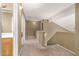 Bright hallway showcasing carpeted floors, neutral walls, and a staircase leading to the upper level at 9343 W Quail Ave, Peoria, AZ 85382
