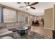 Open-concept living room with a view of the dining area and kitchen, with lots of seating at 9343 W Quail Ave, Peoria, AZ 85382