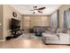 Comfortable living room features a ceiling fan, carpet floors, and ample seating space at 9343 W Quail Ave, Peoria, AZ 85382