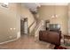 Spacious living area with tile floors and staircase leading to the second floor at 9343 W Quail Ave, Peoria, AZ 85382