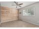 Bedroom featuring wood accent wall, tiled floors, and a window with blinds at 9609 N 44Th Ave, Glendale, AZ 85302