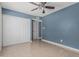 Bedroom boasts tiled floors, a ceiling fan, closet, and an ensuite bathroom at 9609 N 44Th Ave, Glendale, AZ 85302