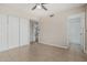 Bedroom featuring tiled floors, ceiling fan, closet, and view to ensuite bathroom at 9609 N 44Th Ave, Glendale, AZ 85302