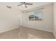 Cozy bedroom with tiled floors, window with blinds, and ceiling fan at 9609 N 44Th Ave, Glendale, AZ 85302