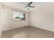 Neutral bedroom features tiled floors, ceiling fan, and window with blinds at 9609 N 44Th Ave, Glendale, AZ 85302