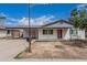Charming single-story home with a covered carport, brick accents, and an inviting red front door at 9609 N 44Th Ave, Glendale, AZ 85302