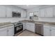 Modern kitchen featuring stainless steel appliances, granite countertops, subway tile backsplash, and ample lighting at 9609 N 44Th Ave, Glendale, AZ 85302