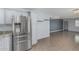 Modern kitchen with stainless steel refrigerator, granite countertops, and ample cabinet space at 9609 N 44Th Ave, Glendale, AZ 85302