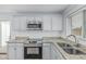 Close-up of a modern kitchen with stainless steel appliances, granite countertops, and subway tile backsplash at 9609 N 44Th Ave, Glendale, AZ 85302