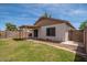 Well-maintained backyard with block fencing, green grass, covered patio and desert landscaping at 10808 W Ruth Ave, Peoria, AZ 85345
