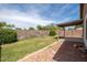 Private backyard with grass, lush greenery, and a covered patio, great for outdoor entertaining at 10808 W Ruth Ave, Peoria, AZ 85345