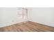Cozy bedroom with wood-look flooring and a window providing natural light at 10808 W Ruth Ave, Peoria, AZ 85345
