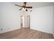A bright bedroom featuring modern flooring, neutral walls, and well-lit by a ceiling fan with overhead light at 10808 W Ruth Ave, Peoria, AZ 85345