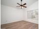 A spacious bedroom with ceiling fan and wood-look flooring, complemented by natural light from a window at 10808 W Ruth Ave, Peoria, AZ 85345