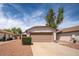 Single-story home showcasing a two-car garage and low-maintenance desert landscaping at 10808 W Ruth Ave, Peoria, AZ 85345