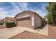 Single-story home with a two-car garage and desert landscaping at 10808 W Ruth Ave, Peoria, AZ 85345