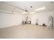 Spacious garage featuring epoxy flooring, overhead lighting, and ample storage, perfect for vehicles and projects at 10808 W Ruth Ave, Peoria, AZ 85345