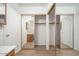 Hallway featuring mirrored closet doors, leading to the bathroom and other rooms at 10808 W Ruth Ave, Peoria, AZ 85345