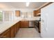 Efficient kitchen boasts stainless steel appliances and wood cabinets, creating a functional workspace at 10808 W Ruth Ave, Peoria, AZ 85345