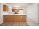 Bright kitchen with wood cabinets, breakfast bar, and access to the backyard at 10808 W Ruth Ave, Peoria, AZ 85345