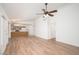 Open-concept living room with stylish flooring, modern fan, and seamless flow to kitchen at 10808 W Ruth Ave, Peoria, AZ 85345