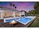 Gorgeous backyard showcasing a pool with a fire pit and an outdoor seating area at 11331 E Cochise Dr, Scottsdale, AZ 85259