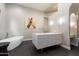 Modern primary bathroom with a sleek vanity, freestanding tub, and elegant finishes with a serene and spa-like feel at 11331 E Cochise Dr, Scottsdale, AZ 85259
