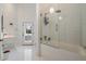 Beautifully designed bathroom with white tiling and a glass-enclosed shower and tub at 11331 E Cochise Dr, Scottsdale, AZ 85259
