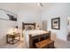 Cozy primary bedroom featuring rustic accents, neutral carpet, and a view into the primary bathroom at 11331 E Cochise Dr, Scottsdale, AZ 85259