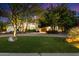 Well-manicured lawn and mature trees frame this beautiful home and entrance at 11331 E Cochise Dr, Scottsdale, AZ 85259