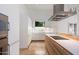 Contemporary kitchen with white cabinets, integrated appliances, and sleek design at 11331 E Cochise Dr, Scottsdale, AZ 85259