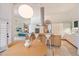 Open-concept kitchen with island seating, adjacent dining area, and modern finishes at 11331 E Cochise Dr, Scottsdale, AZ 85259